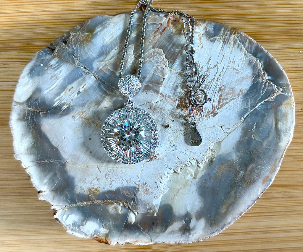 Moissanite necklace. The certified 2ct Moissanite “Sunburst” necklace with a 61 gemstone pendant plus more in the bail! Radiantly beautiful!