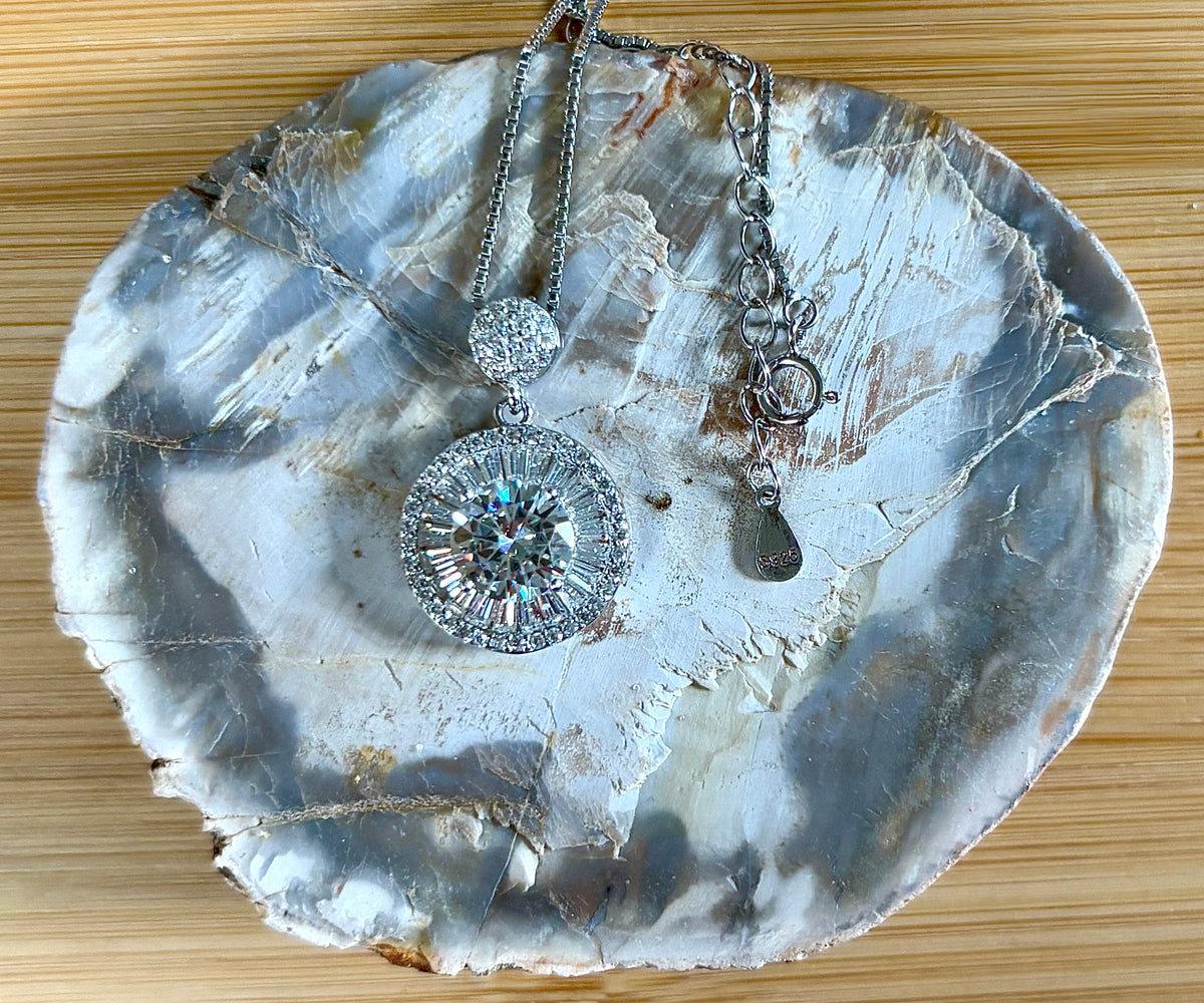 Moissanite necklace. The certified 2ct Moissanite “Sunburst” necklace with a 61 gemstone pendant plus more in the bail! Radiantly beautiful!