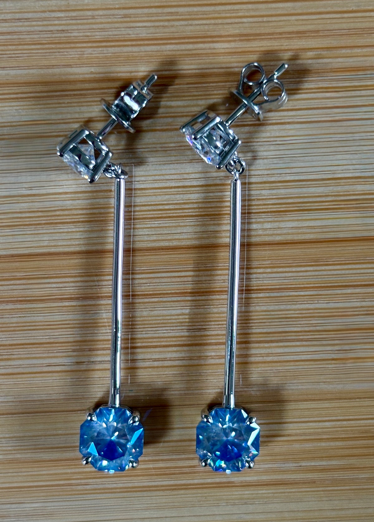 8ctw Moissanite pendulum earrings, with 3ct octagonal frosty aquamarine Moissanites at the bottom of the pendulum, and 1ct white round brilliant Moissanites at the top! Full Argentium silver construction with sterling silver disk backs! An HKJ exclusive!