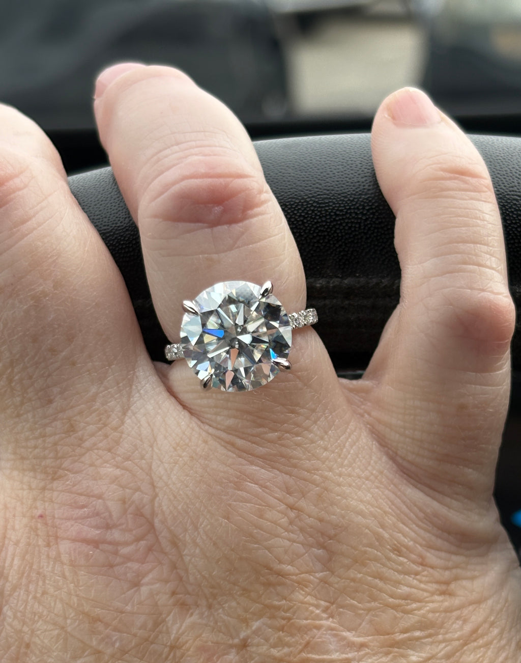 Moissanite solitaire. A glorious 10ct 8H8A Moissanite in a 4-prong mounting with a Moissanite “hidden halo” and shoulders, an 11.3cttw ring!
