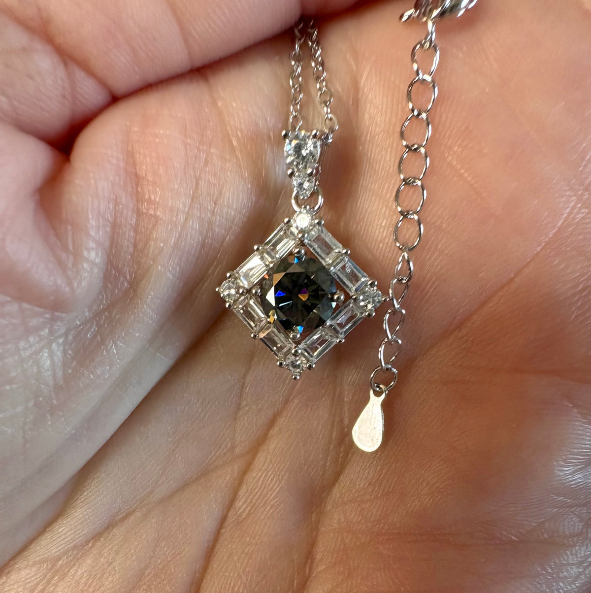 Moissanite necklace. A transfixingly gray 1ct certified round brilliant Moissanite centered in a halo of white zircons - a 2.25cttw pendant!