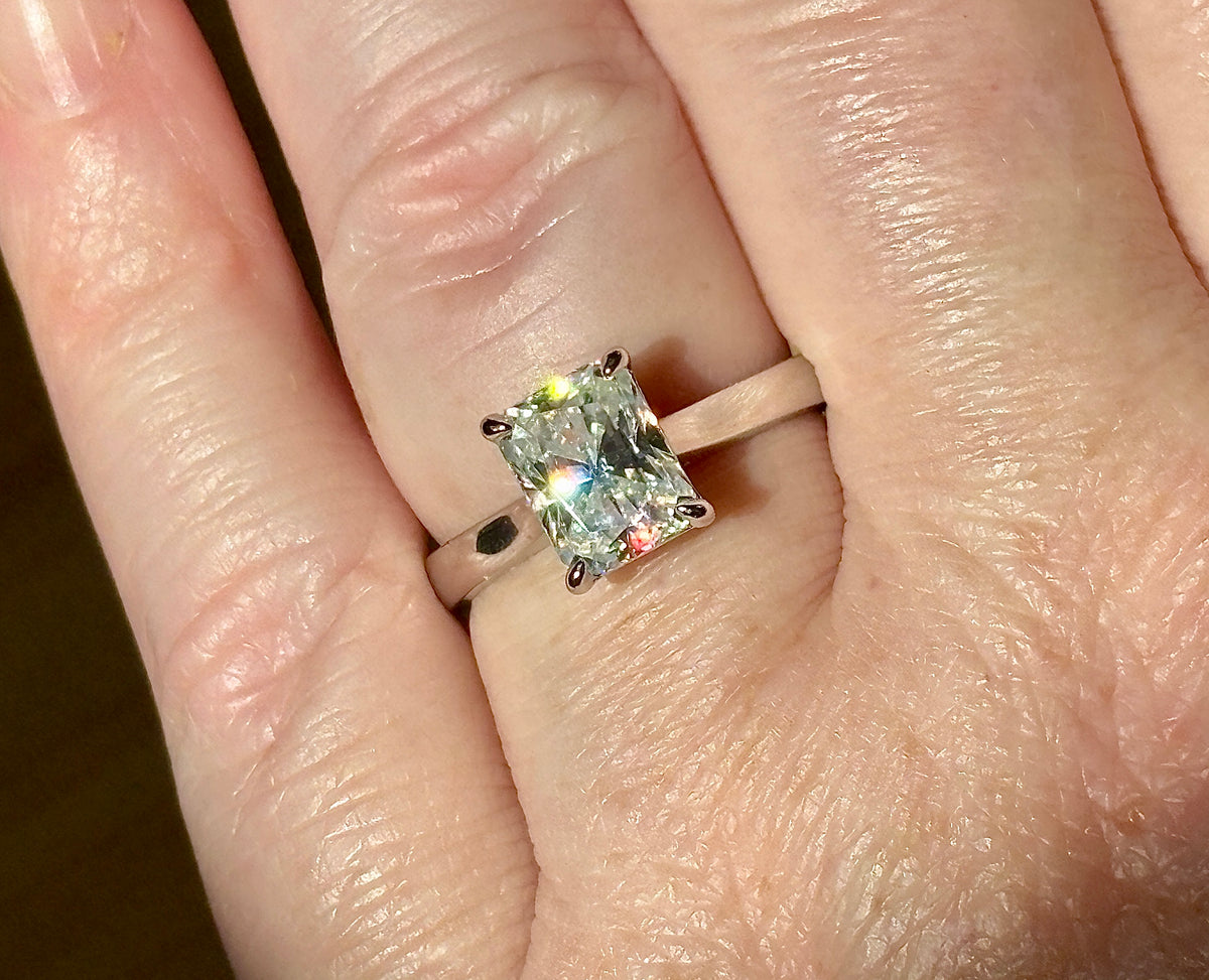 A certified Moissanite 3ct radiant solitaire! An UBER flashy, ULTRA classy, contemporary and chic radiant-cut engagement ring!