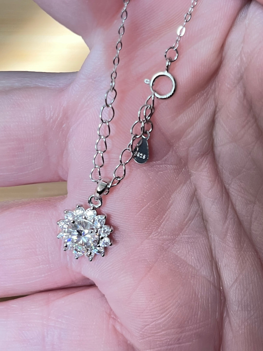 Moissanite necklace. A 1ct or 3ct Moissanite in a halo of sparkling white zircons (I call it the “Sunflower” pendant)! In sterling silver and 18k!