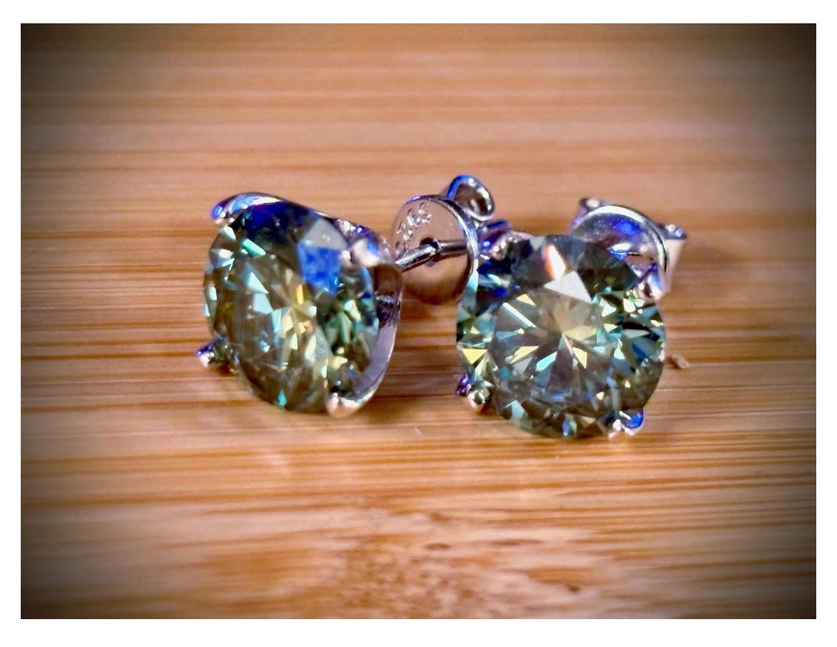 Moissanite studs. A 2cttw or 6cttw pair of cyan (greenish-blue) Moissanite studs. Double certified and rich in color, they are delicious!