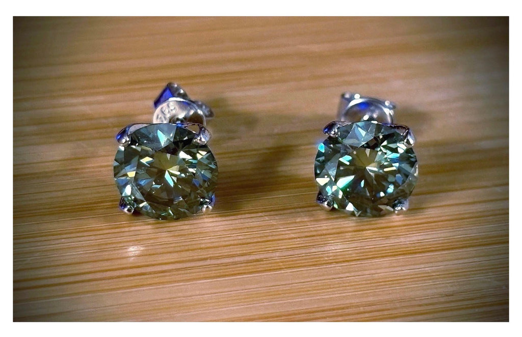 Moissanite studs. A 2cttw or 6cttw pair of cyan (greenish-blue) Moissanite studs. Double certified and rich in color, they are delicious!