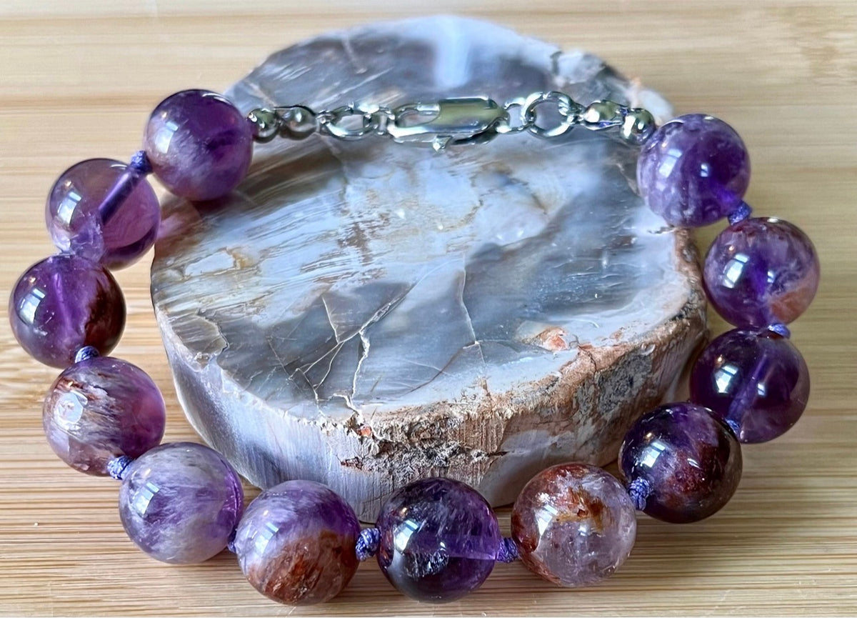 Super seven amethyst bracelet. AAA-grade 12mm “super seven”, mineral name cacoxenite amethyst, hand-knotted with silvery or golden hardware!