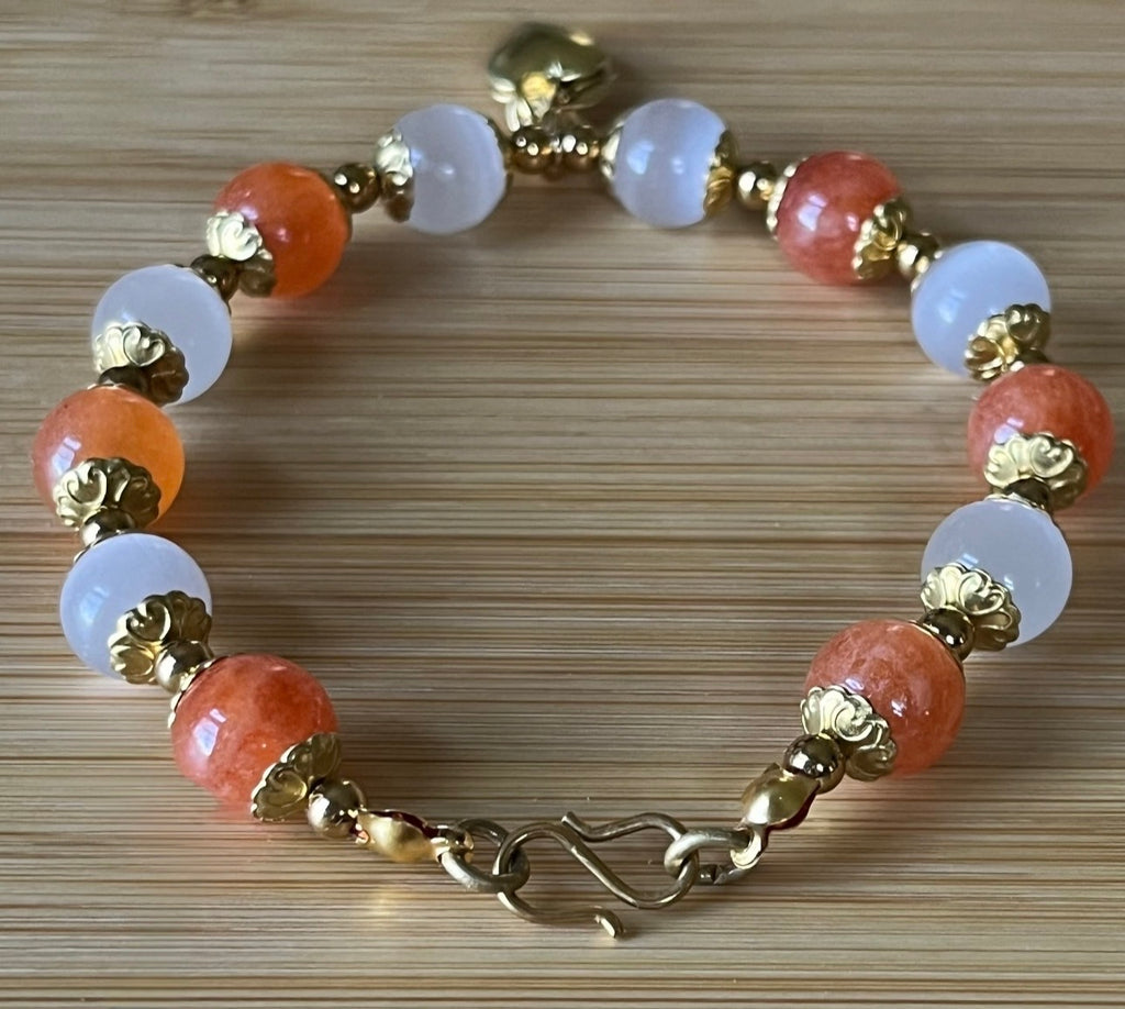 White selenite and tangerine chalcedony bracelet with raw brass and stainless steel components. The functioning brass locket is included!