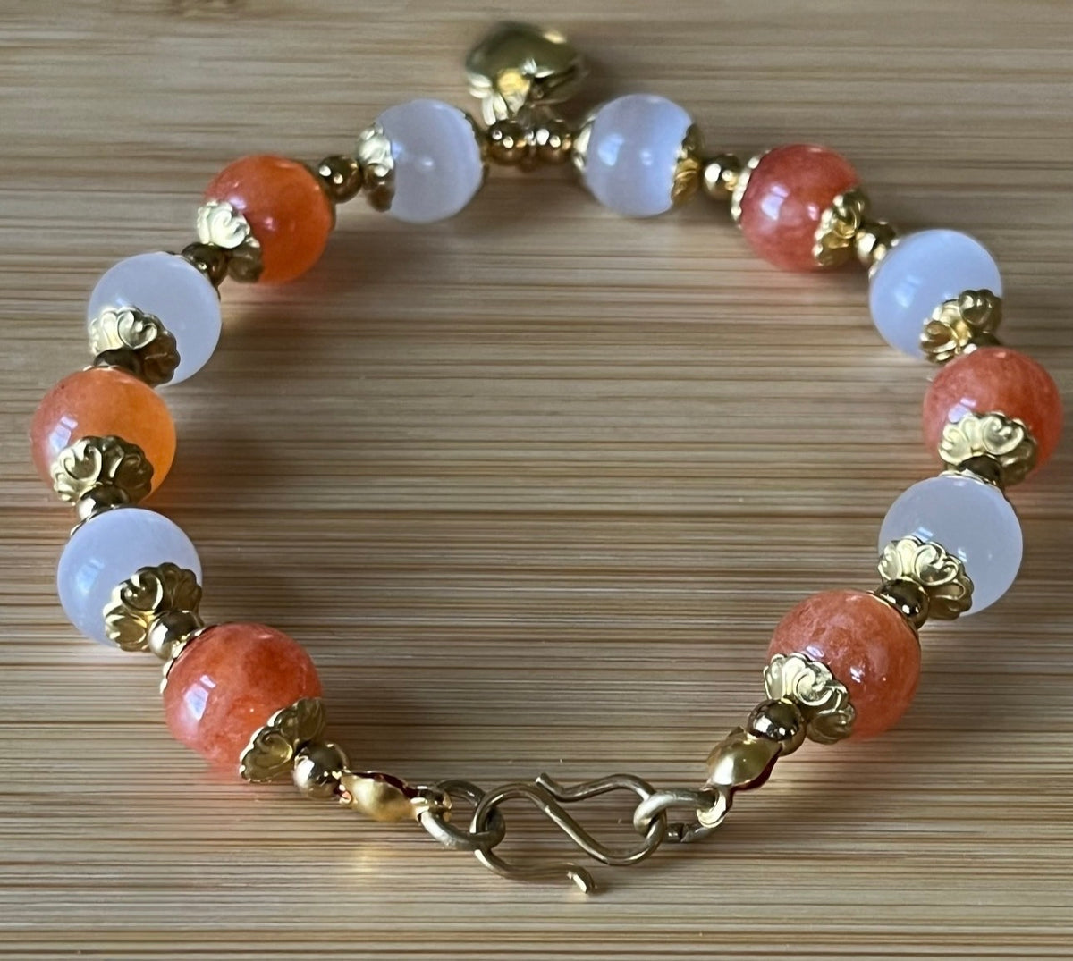 White selenite and tangerine chalcedony bracelet with raw brass and stainless steel components. The functioning brass locket is included!