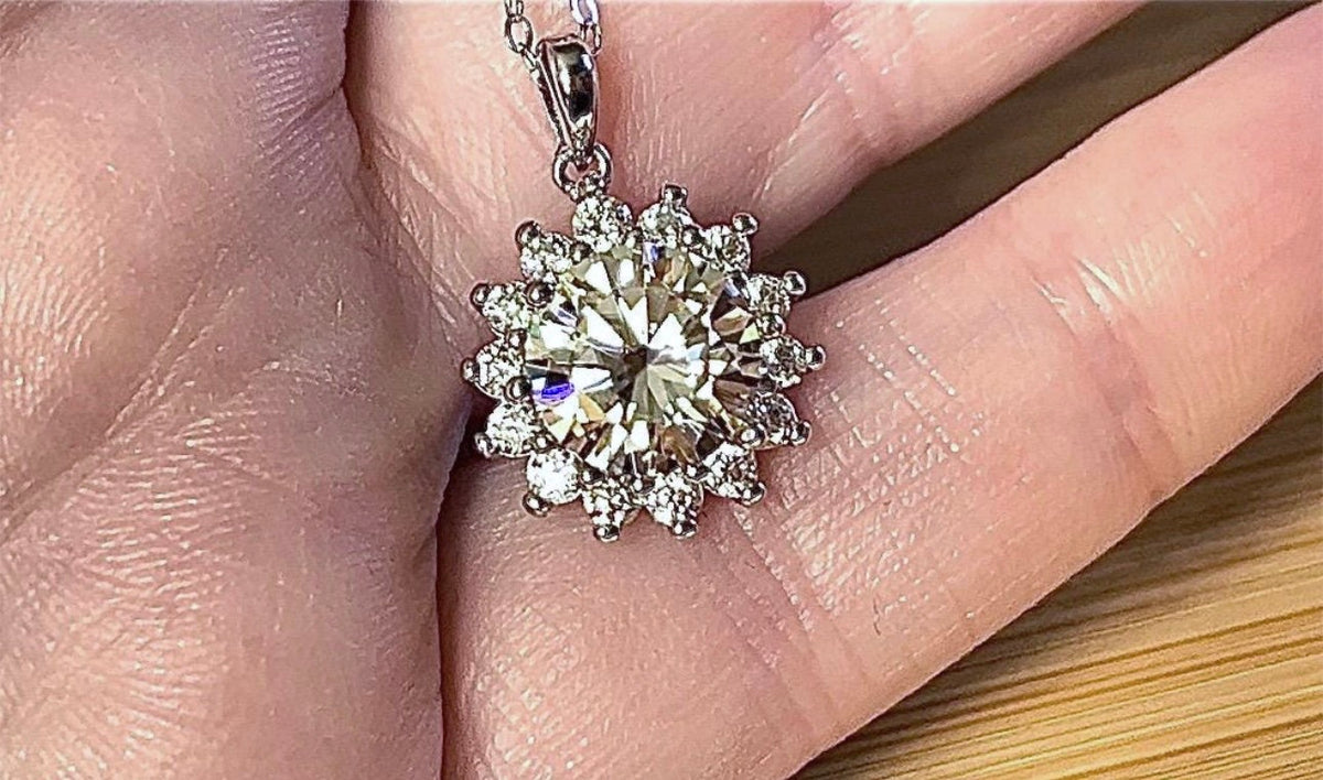 Moissanite necklace. A 1ct or 3ct Moissanite in a halo of sparkling white zircons (I call it the “Sunflower” pendant)! In sterling silver and 18k!