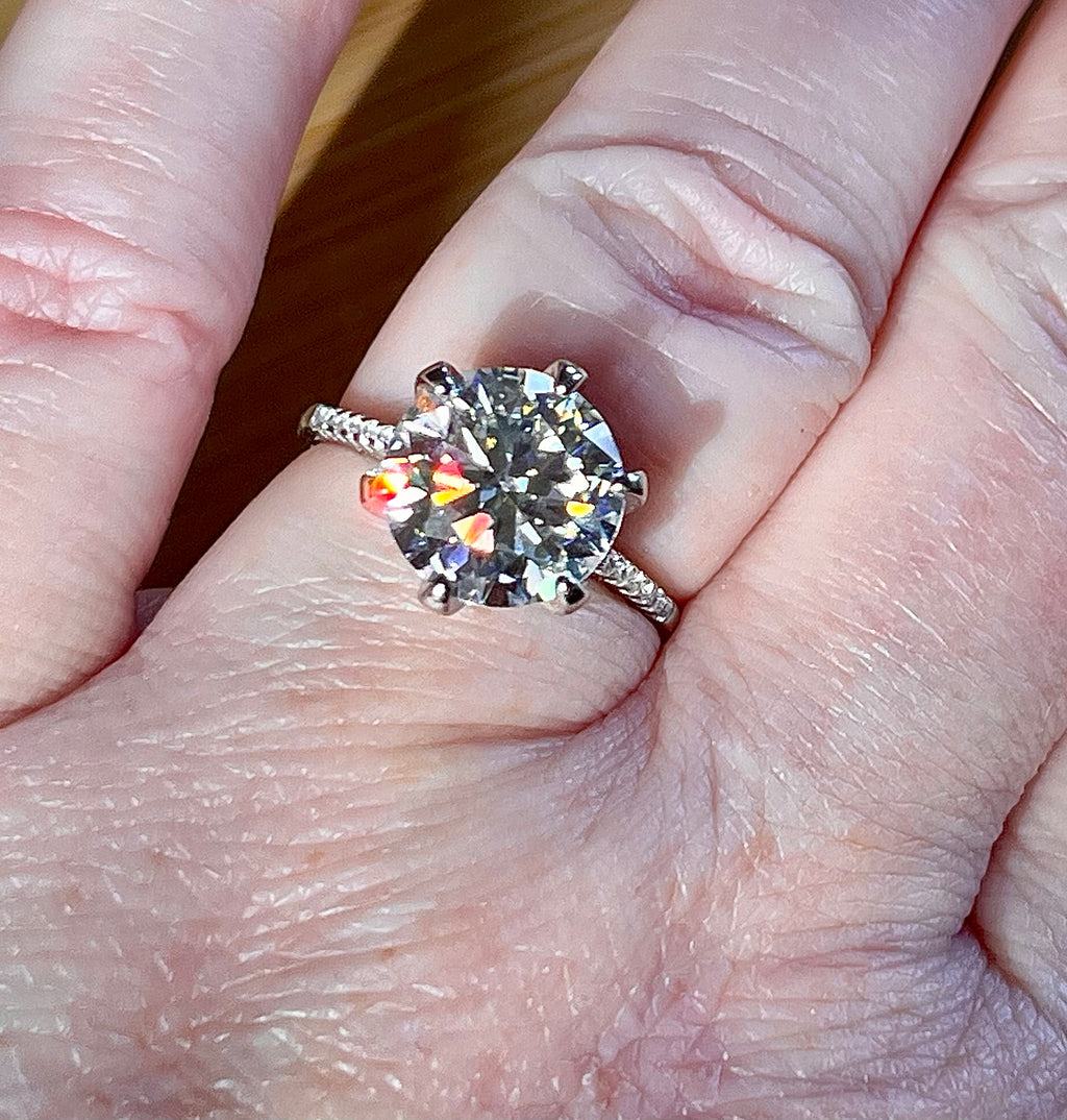 Moissanite ring. A certified 5ct Moissanite solitaire with zircon-accented shoulders, set in sterling silver and bathed in 18k!