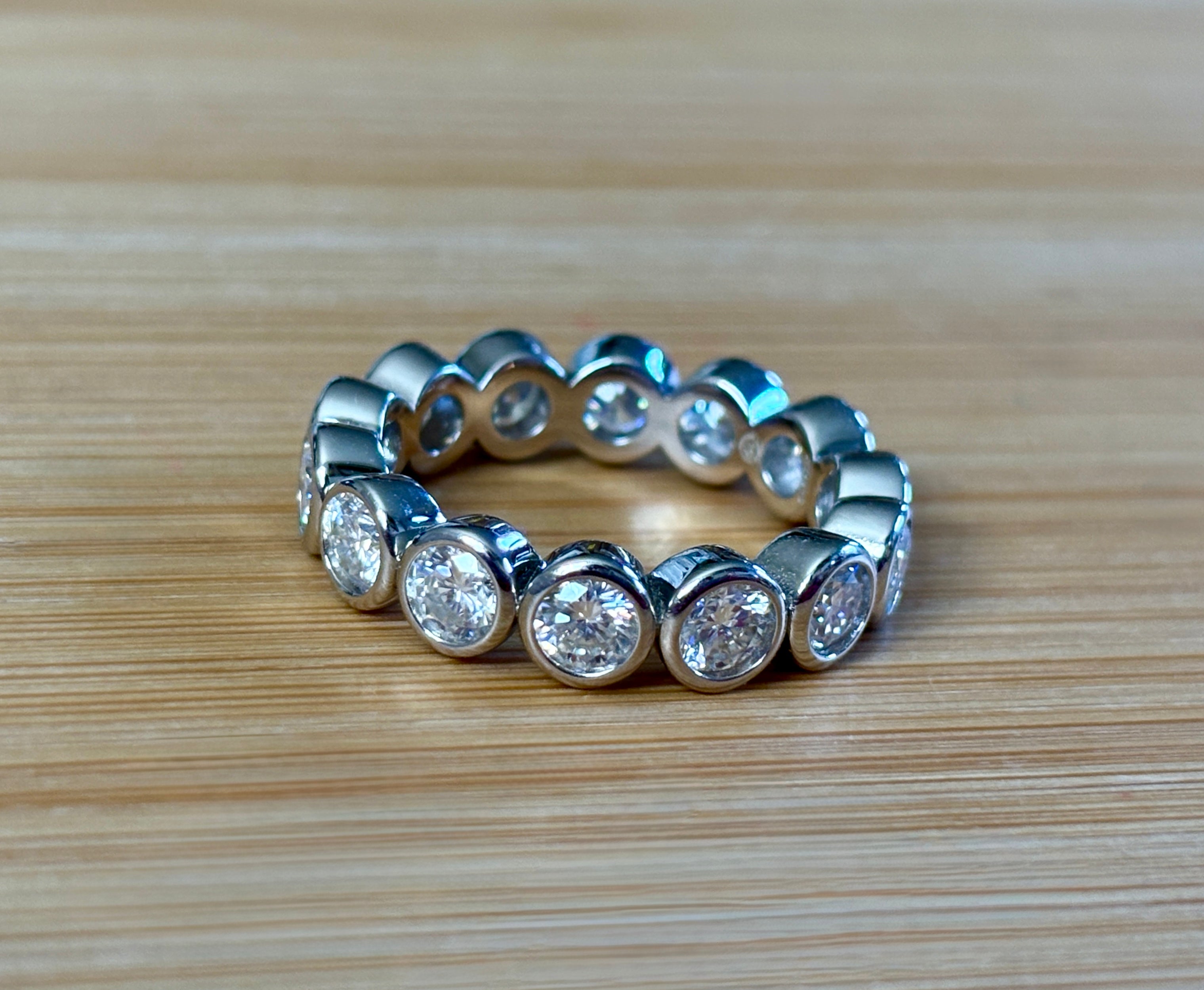 Moissanite ring. A certified, bezel-set eternity ring with 1/2ct round brilliant Moissanites set in a heavy, solid Argentium silver band!