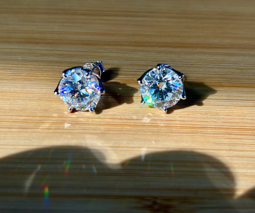 A 10ctw pair of double certified Moissanite studs in lotus-shaped sterling silver baskets!