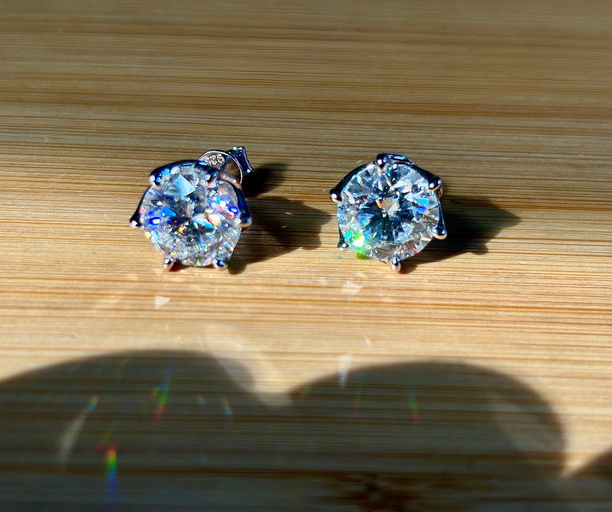A 10ctw pair of double certified Moissanite studs in lotus-shaped sterling silver baskets!