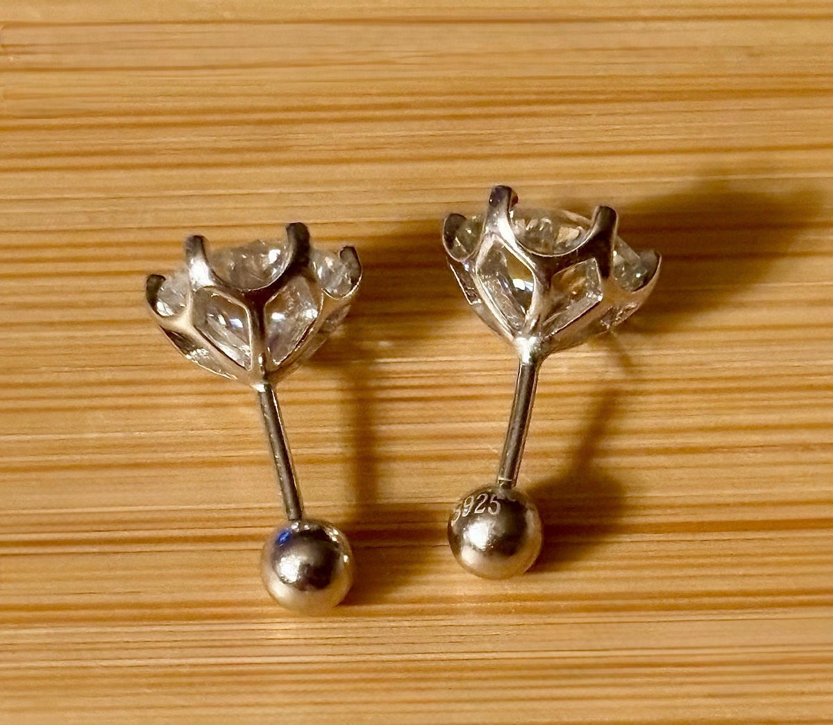 A certified pair of pretty, floral-inspired 2cttw or 4cttw Moissanite studs in poinsettia-shaped settings w/screwball backs OR 4cttw w/push backs!