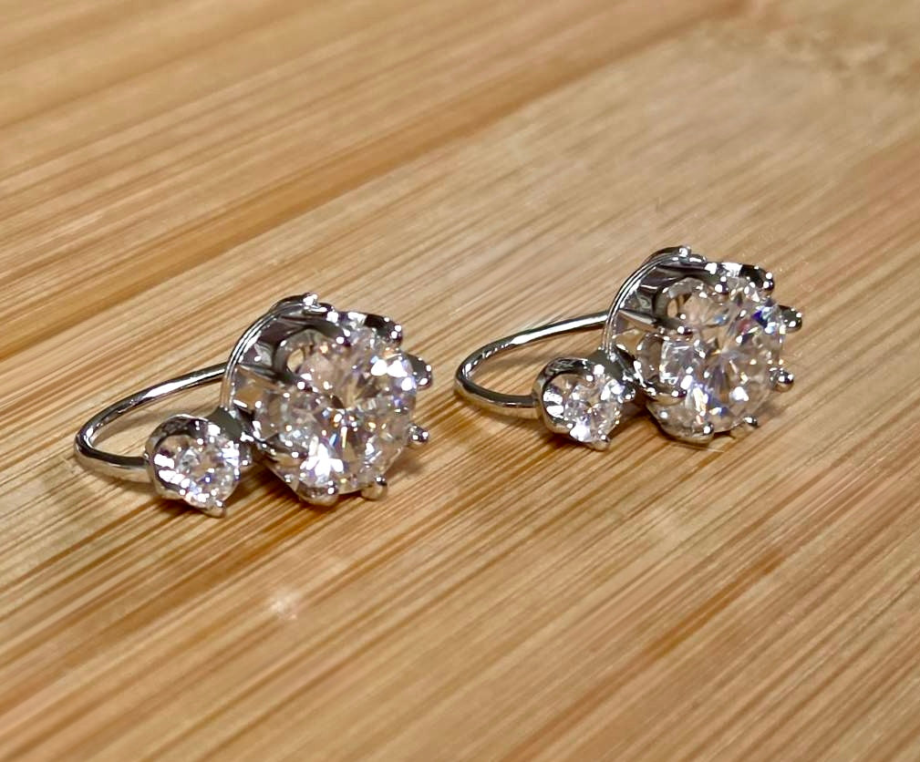 A Victorian inspired 4.2cttw certified pair of Moissanite 2-stone buckle back earrings in Argentium silver! Minimalist glam!
