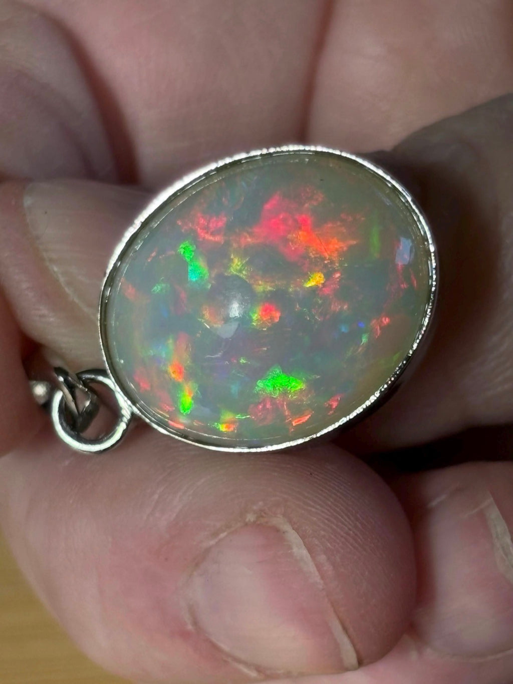 A 17.28ct AAA grade Ethiopian opal pendant with multi-patterned fire and beautiful play of color, hand-picked by Hand Knotted Jewelry!