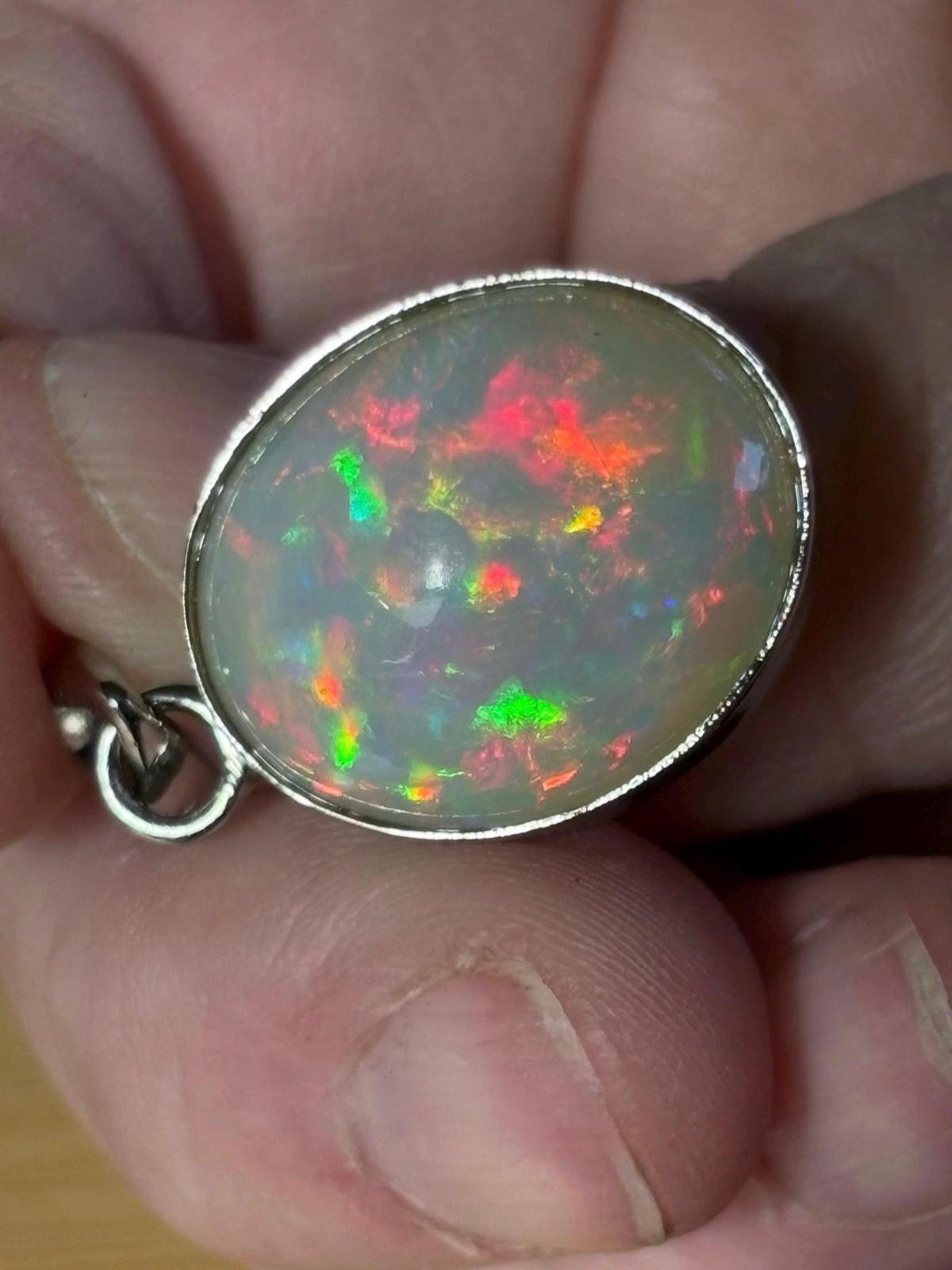 A 17.28ct AAA grade Ethiopian opal pendant with multi-patterned fire and beautiful play of color, hand-picked by Hand Knotted Jewelry!