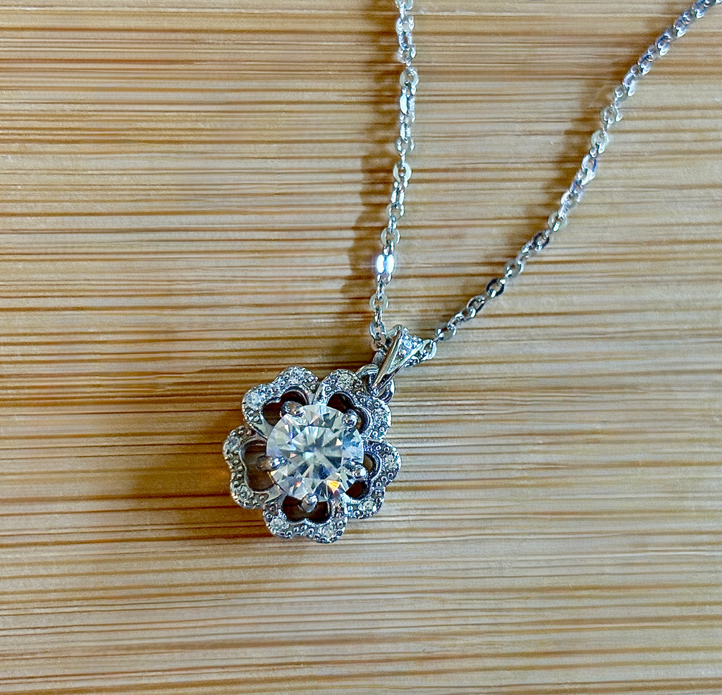 Moissanite necklace. A certified 1ct Moissanite hibiscus necklace with white zircon accents in solid sterling and white rhodium!
