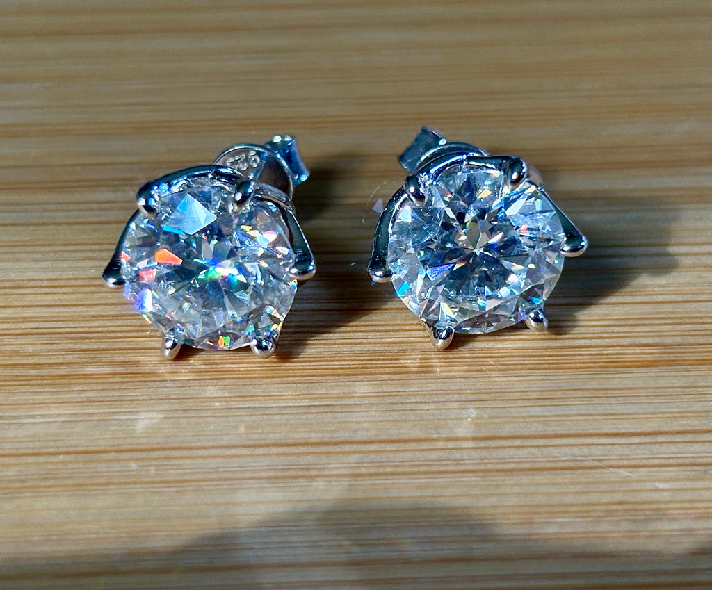 A 10ctw pair of double certified Moissanite studs in lotus-shaped sterling silver baskets!