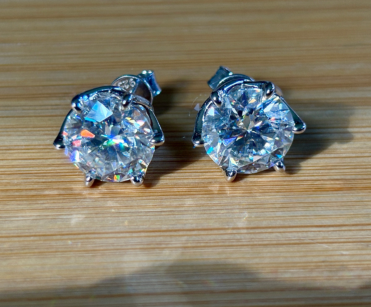 A 10ctw pair of double certified Moissanite studs in lotus-shaped sterling silver baskets!
