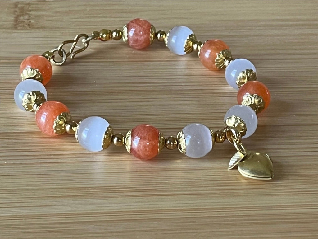White selenite and tangerine chalcedony bracelet with raw brass and stainless steel components. The functioning brass locket is included!