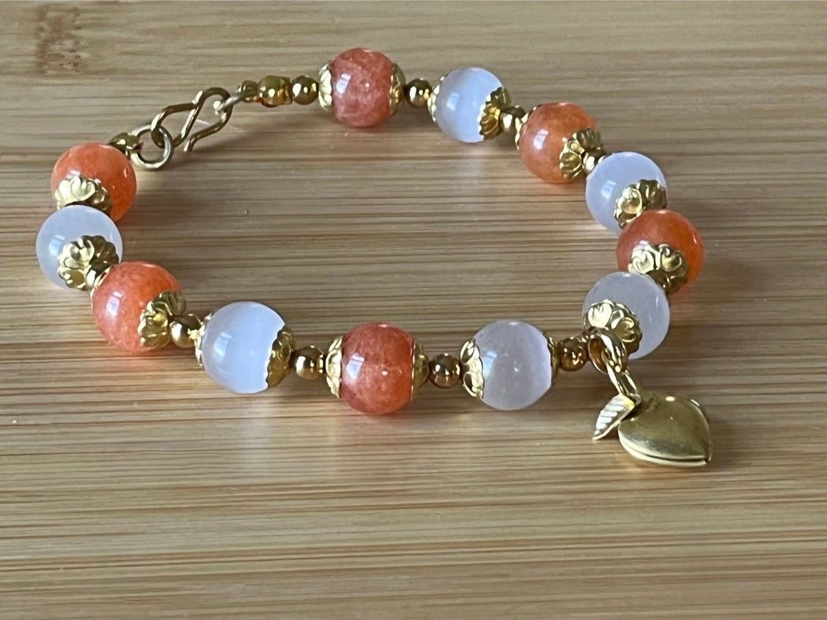 White selenite and tangerine chalcedony bracelet with raw brass and stainless steel components. The functioning brass locket is included!