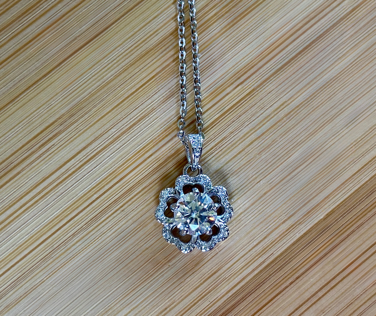 Moissanite necklace. A certified 1ct Moissanite hibiscus necklace with white zircon accents in solid sterling and white rhodium!