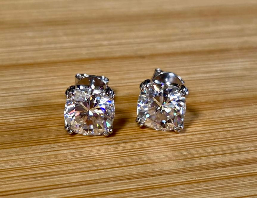 6ctw cushion-cut Moissanite studs in elegant sterling silver double-claw mountings! With brilliant faceting, these earrings are showstoppers!