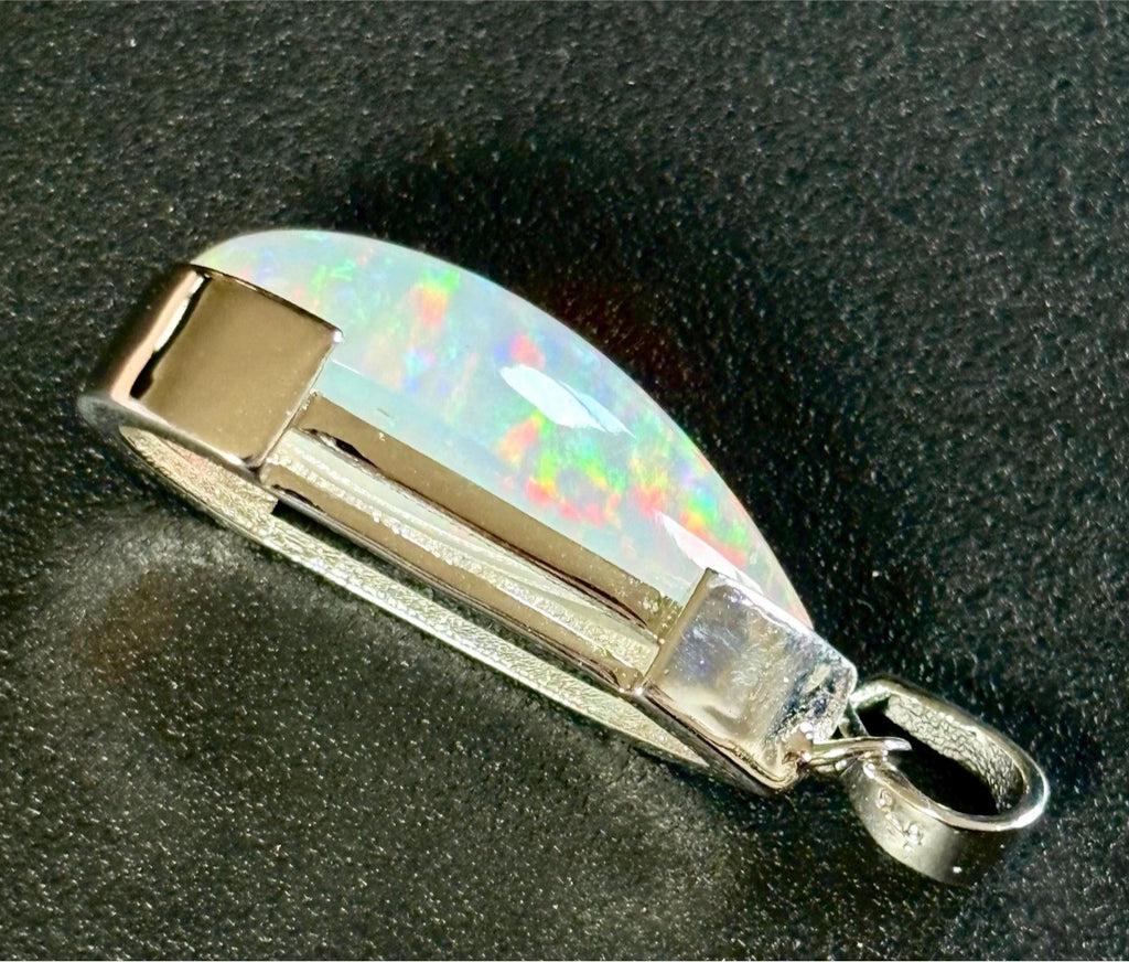 A GORGEOUS 11.05ct AAA+ grade Ethiopian pendant, an elongated pear-shaped cabochon with galaxy pattern fire and phenomenal play of color!