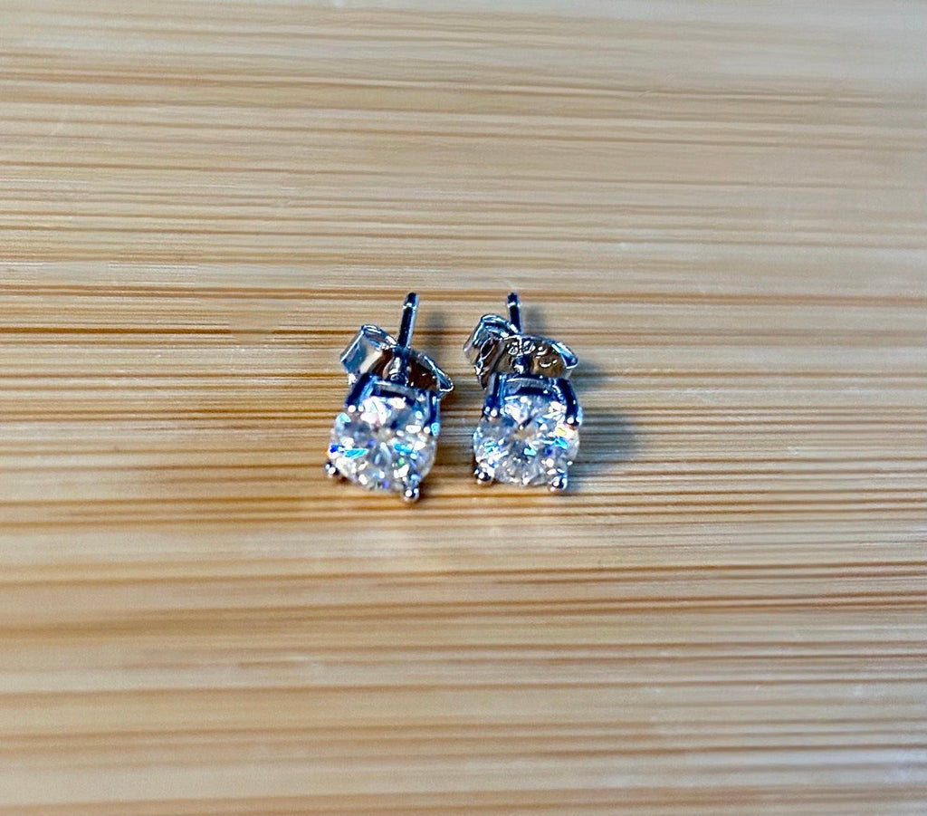 1cttw DOUBLE certified Moissanite studs with D-color and VVS1 clarity! Set in sterling silver bathed in 18k white gold, they’re a cut above!