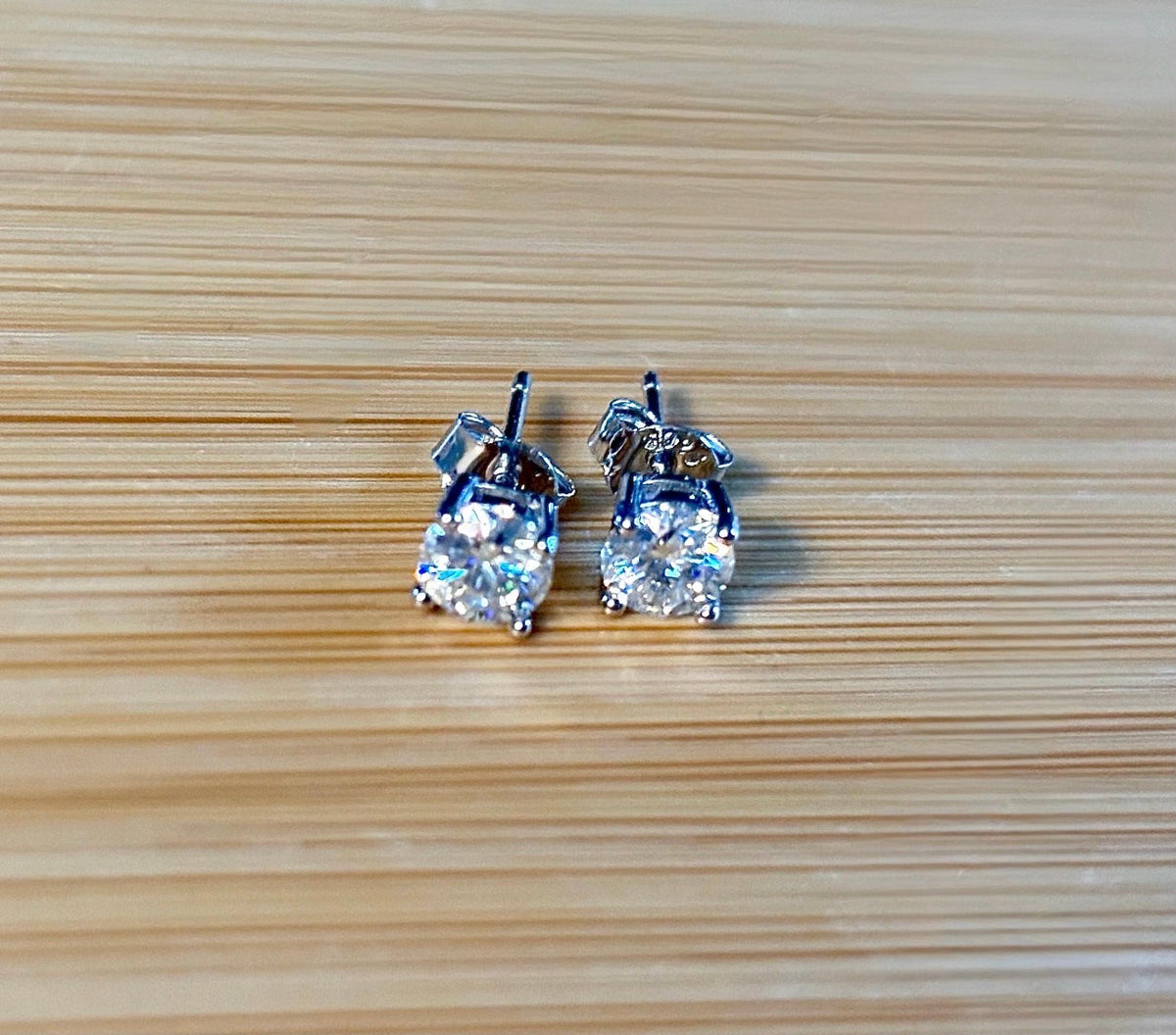 1cttw DOUBLE certified Moissanite studs with D-color and VVS1 clarity! Set in sterling silver bathed in 18k white gold, they’re a cut above!