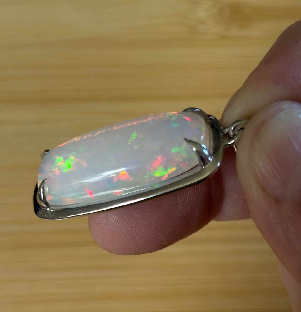 A 21ct AAA grade Ethiopian opal pendant, a handpicked opal and exclusive HKJ design! This lovely opal has gorgeous fire and play of color!