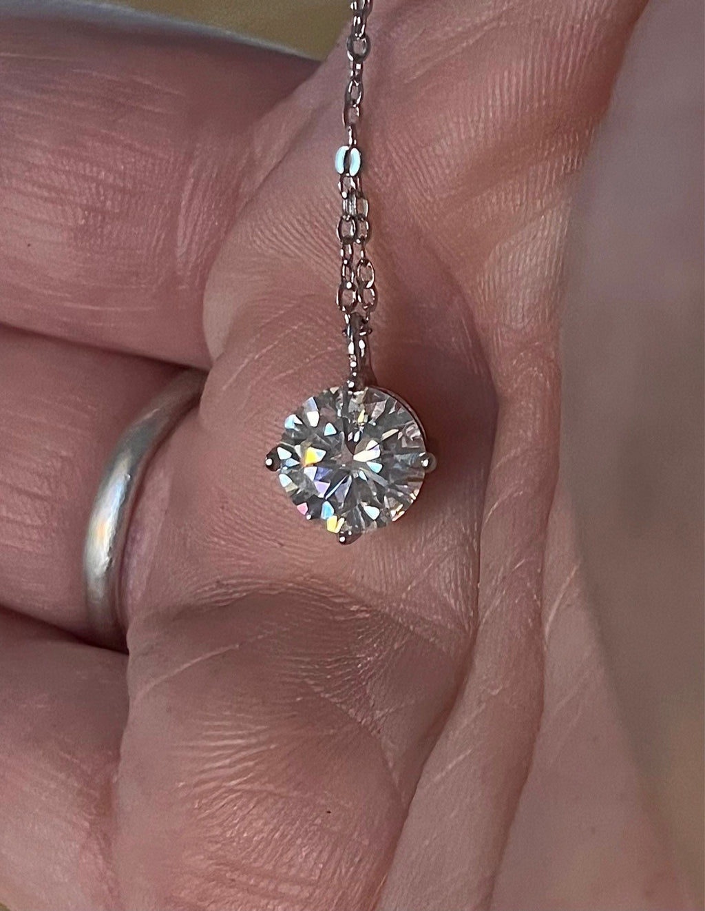 2ct Moissanite solitaire necklace. A 2ct “Floating Moissanite” in sterling silver creates the illusion of being suspended by nothing more than spider silk!