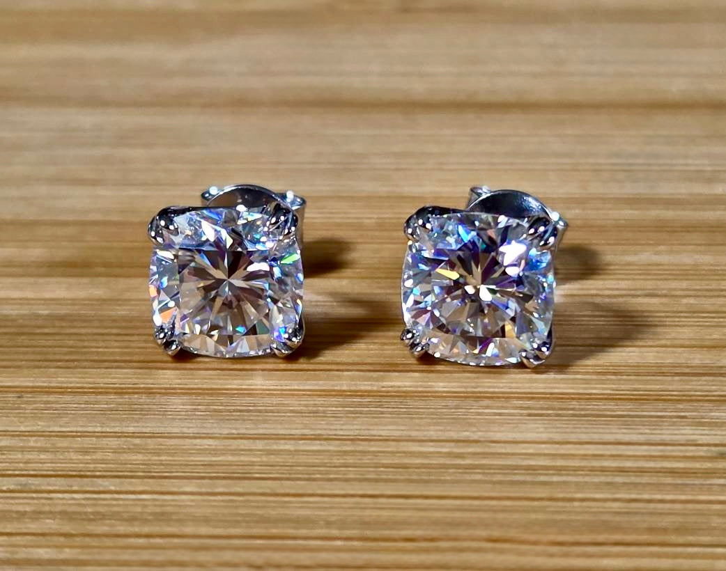 6ctw cushion-cut Moissanite studs in elegant sterling silver double-claw mountings! With brilliant faceting, these earrings are showstoppers!