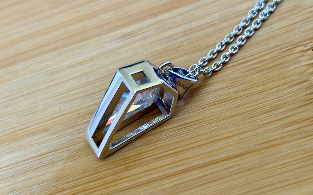 Moissanite necklace. “Flight!”, a kite-shaped, custom-cut 5ct Moissanite pendant! Hand-faceted by a master stone cutter and set in Argentium silver, it is suspended on a 20” sterling silver chain and is exclusive to Hand Knotted Jewelry!
