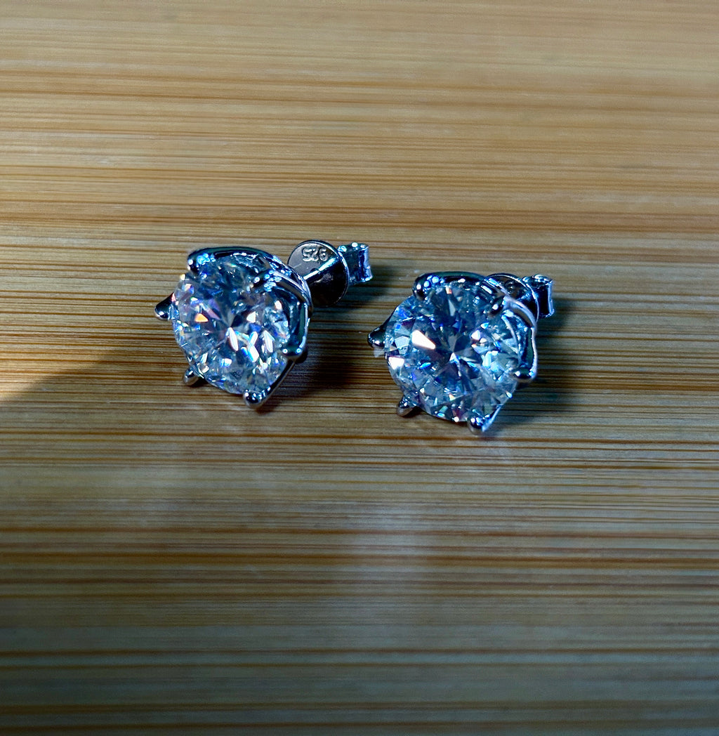 A 10ctw pair of double certified Moissanite studs in lotus-shaped sterling silver baskets!