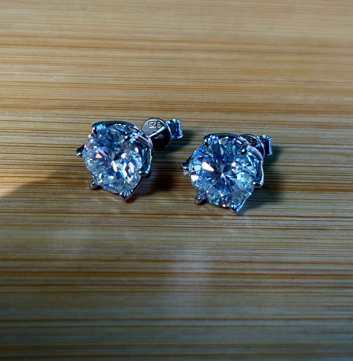 A 10ctw pair of double certified Moissanite studs in lotus-shaped sterling silver baskets!