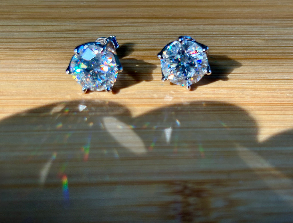 A 10ctw pair of double certified Moissanite studs in lotus-shaped sterling silver baskets!