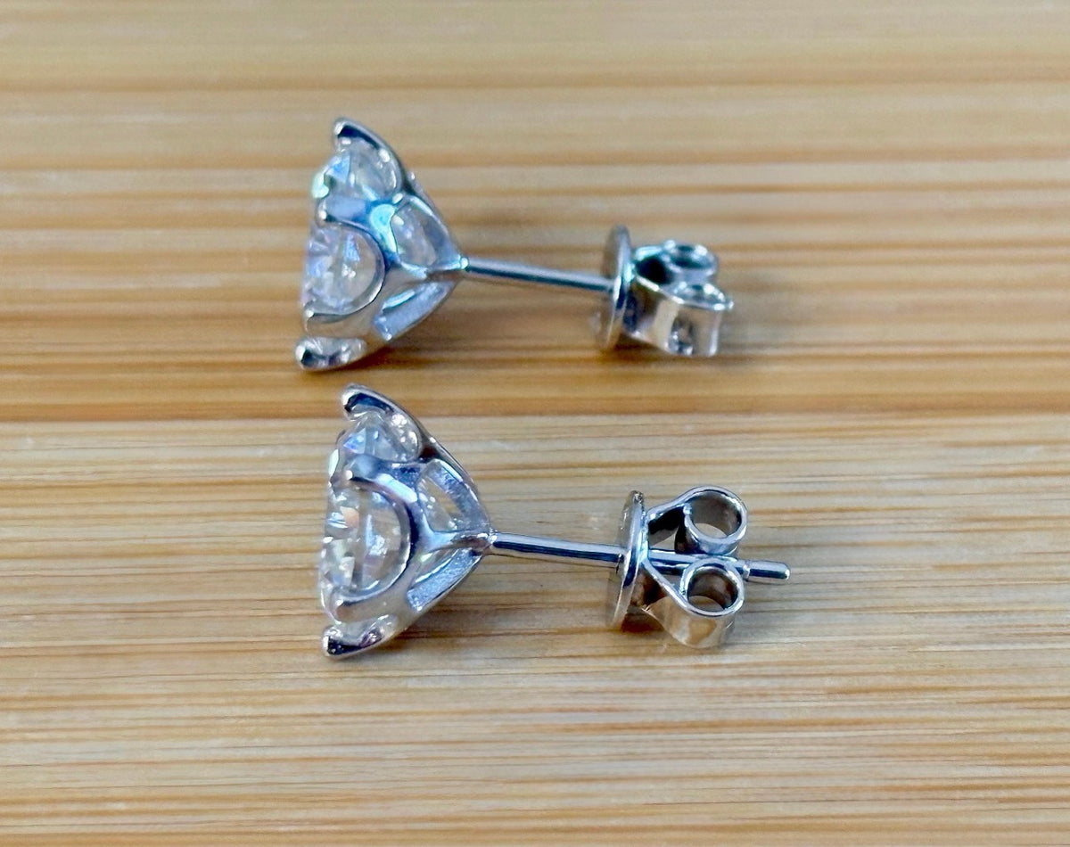 A certified pair of pretty, floral-inspired 2cttw or 4cttw Moissanite studs in poinsettia-shaped settings w/screwball backs OR 4cttw w/push backs!