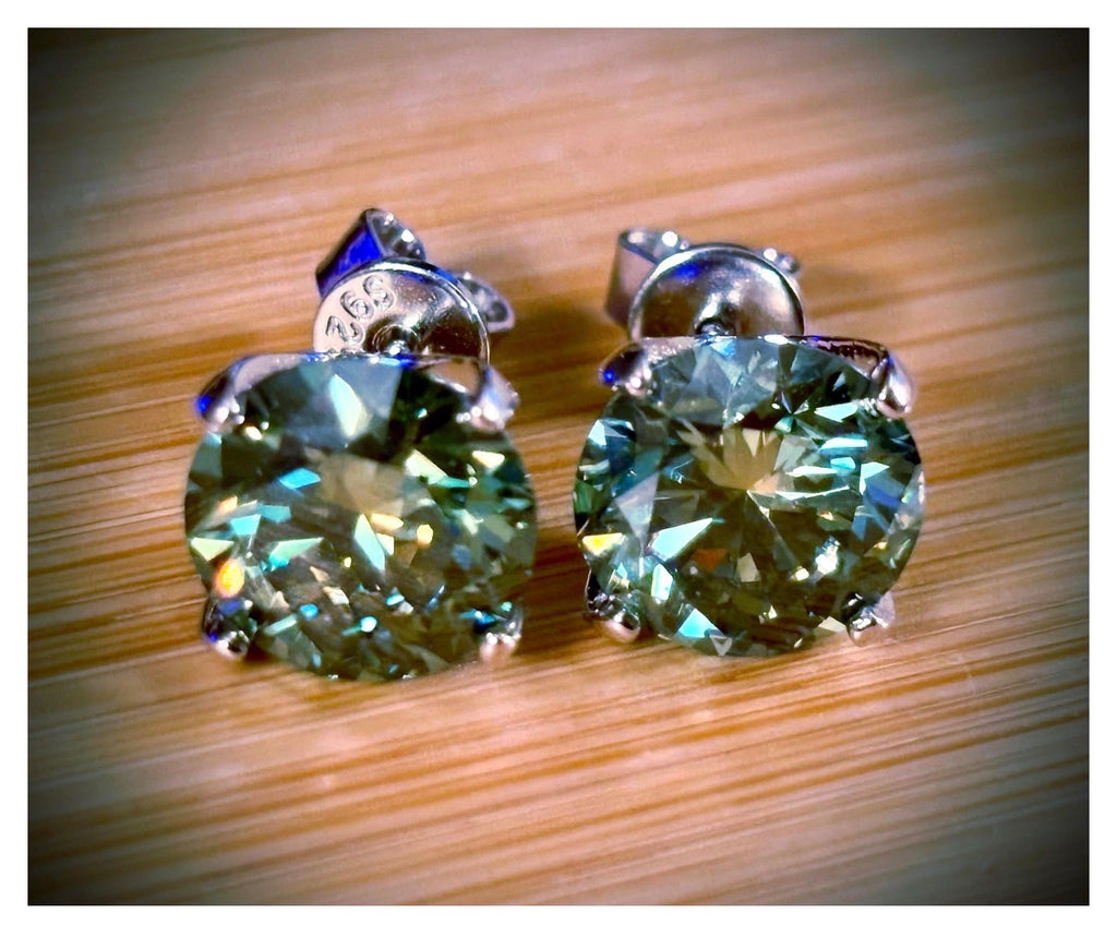 Moissanite studs. A 2cttw or 6cttw pair of cyan (greenish-blue) Moissanite studs. Double certified and rich in color, they are delicious!