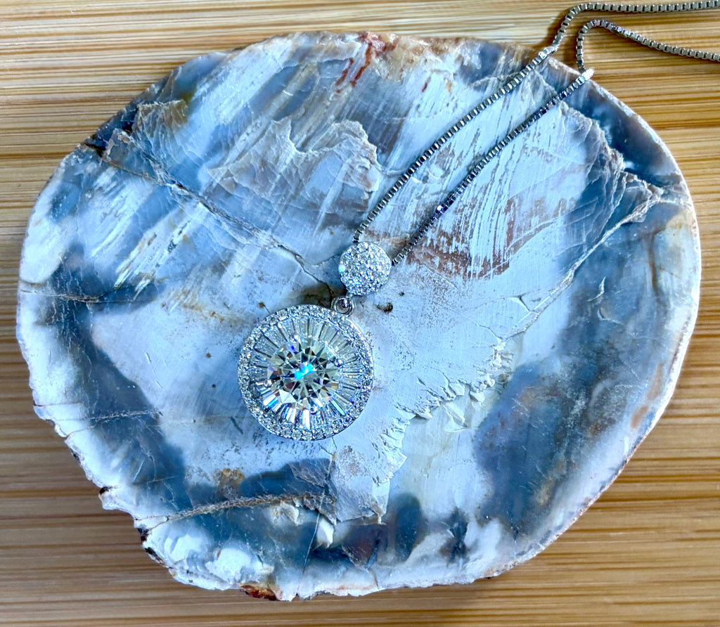 Moissanite necklace. The certified 2ct Moissanite “Sunburst” necklace with a 61 gemstone pendant plus more in the bail! Radiantly beautiful!