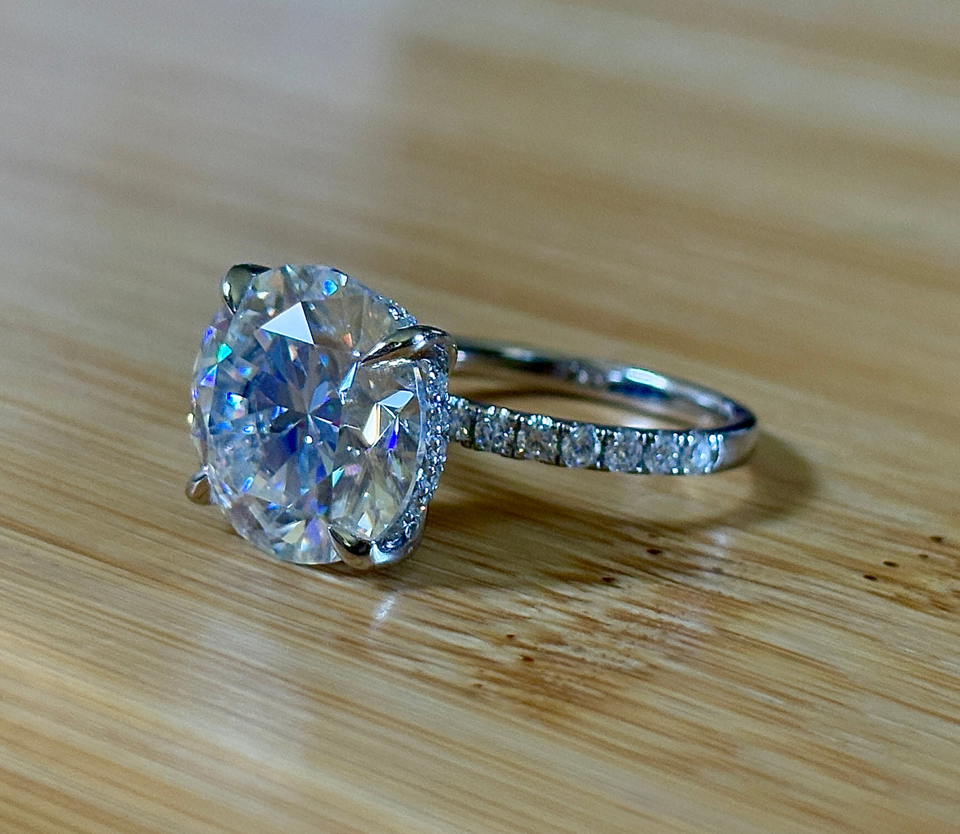 Moissanite solitaire. A glorious 10ct 8H8A Moissanite in a 4-prong mounting with a Moissanite “hidden halo” and shoulders, an 11.3cttw ring!
