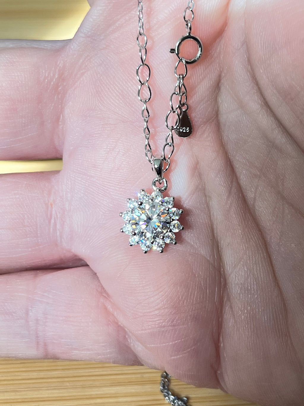 Moissanite necklace. A 1ct or 3ct Moissanite in a halo of sparkling white zircons (I call it the “Sunflower” pendant)! In sterling silver and 18k!