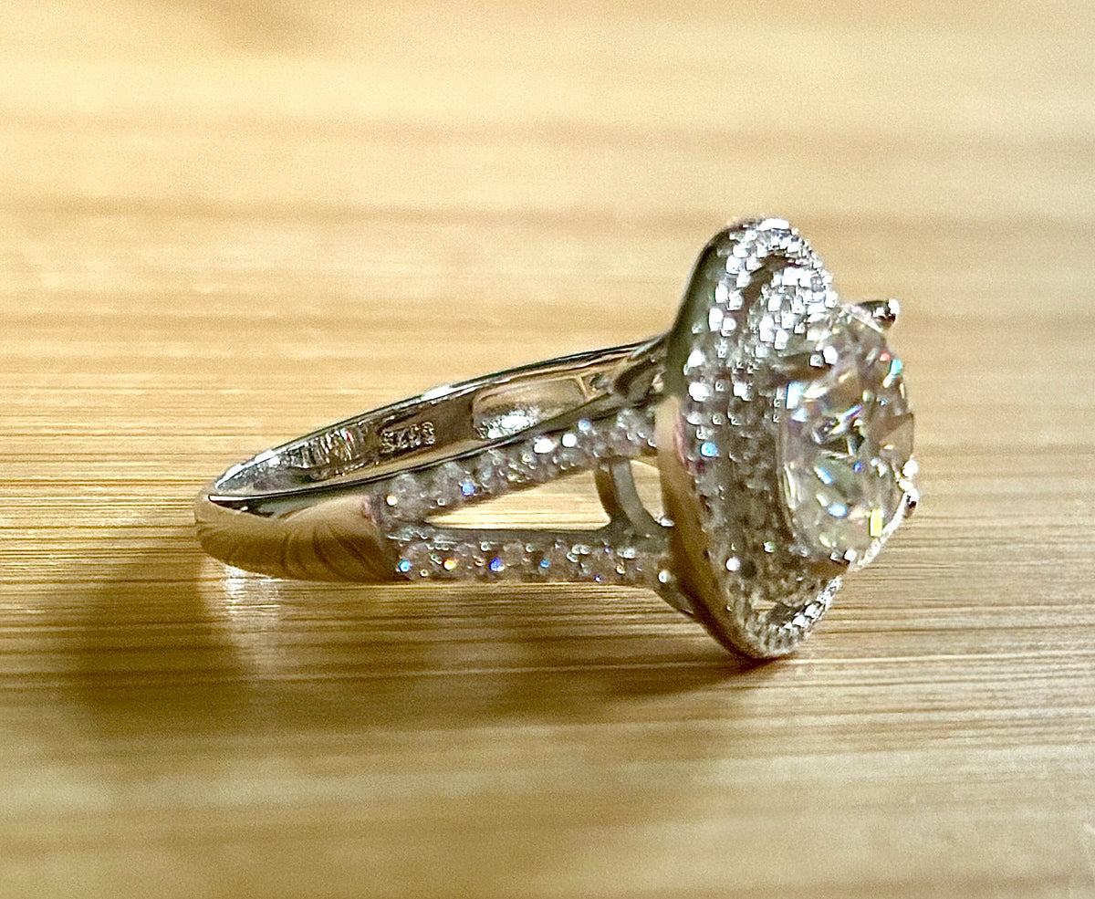 Moissanite ring. The 6.64cttw *fully* Moissanite “Bull’s Eye” ring, featuring a 4ct certified round brilliant Moissanite in a double halo!