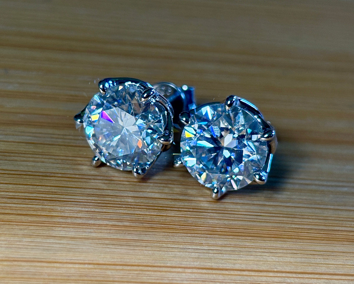A 10ctw pair of double certified Moissanite studs in lotus-shaped sterling silver baskets!