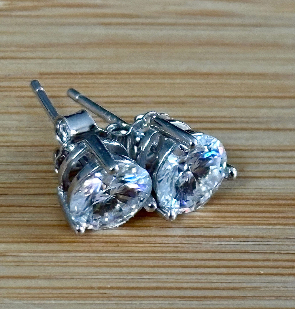 Moissanite earrings. A delicate certified 2cttw pair of 3-prong or 4-prong round brilliant Moissanites in 18k gold-embraced sterling silver baskets! Classic!