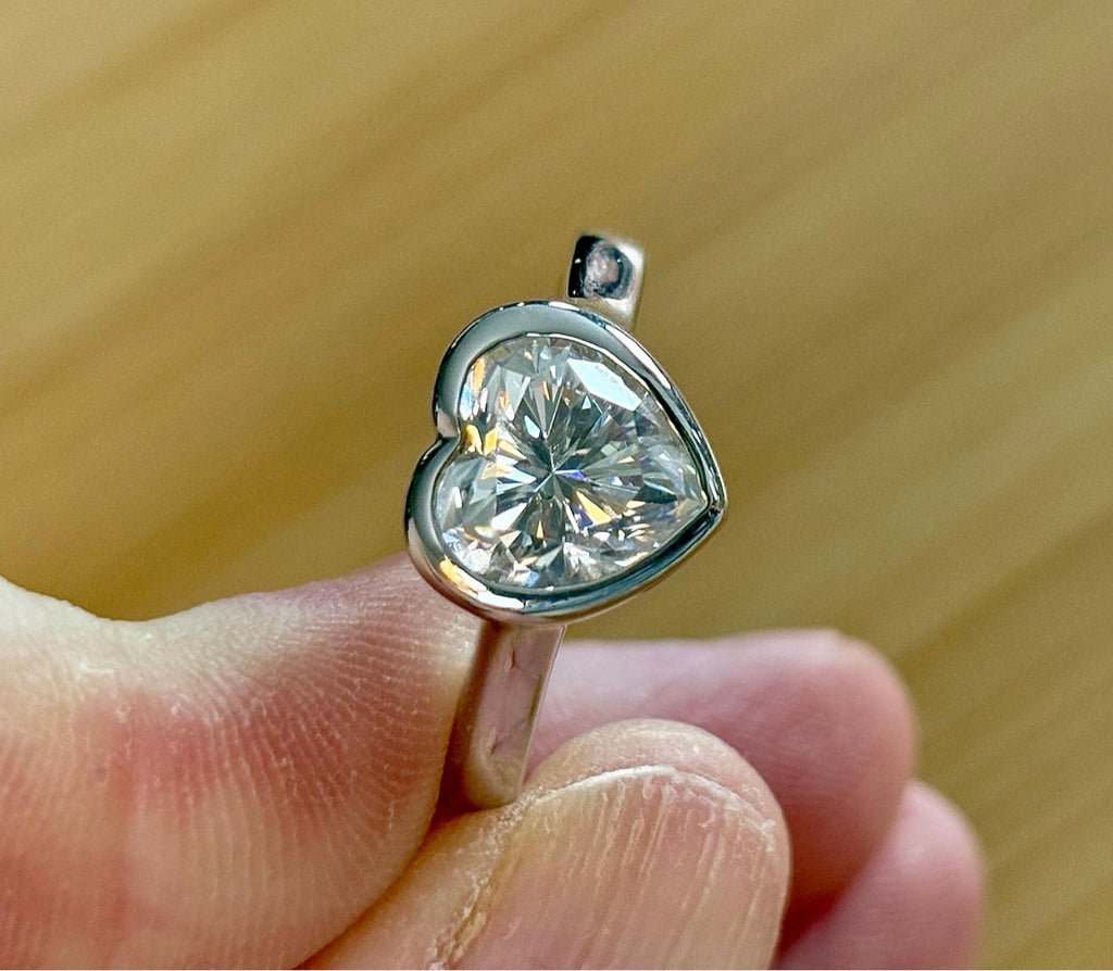 Moissanite ring. A high-end solitaire with a certified 3ct heart-cut stone, bezel-set in a heavy sterling silver mounting and bathed in 18k!
