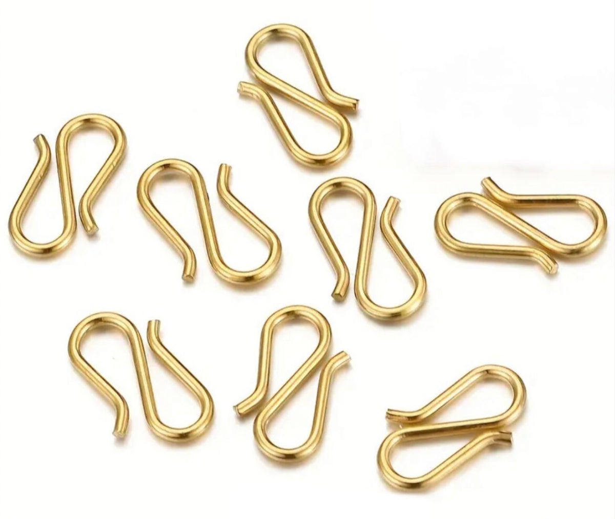 Small sterling silver cross charms, stainless steel double lobster clasps and stainless steel S-hooks for various jewelry applications.
