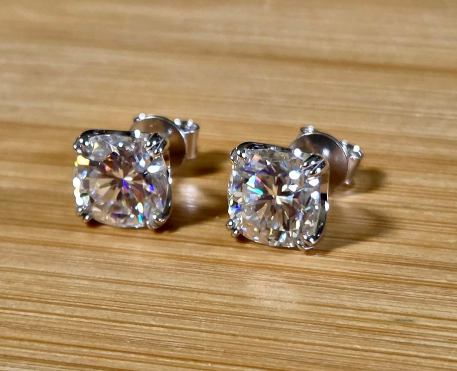 6ctw cushion-cut Moissanite studs in elegant sterling silver double-claw mountings! With brilliant faceting, these earrings are showstoppers!