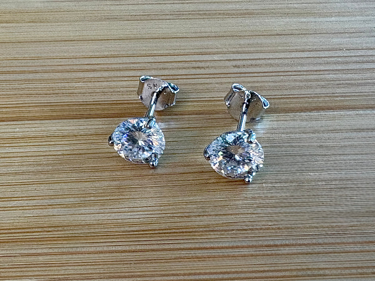 Moissanite studs. A 100-facet 2cttw pair of super bright, DOUBLE certified Moissanite studs in sterling silver and 18k white rhodium! Sublime!